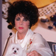 Liz Taylor greets the press and adoring fans following surgery to remove years of excess jewel build-up in her brain.